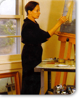 The artist, Denise Kelly, painting in her studio in Truro, MA.
